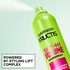 A close-up action shot of the hairspray being used. Text at the bottom left reads "POWERED BY STYLING LIFT COMPLEX".