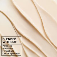 Macro texture shot of creamy Garnier Whole Blends Honey Treasures Rich Repairing Mask: a hair treatment for damaged hair blended without parabens, phthalates, mineral oils, or DMDM hydantoin.
