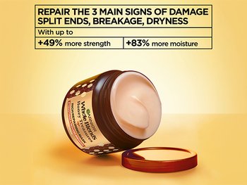Garnier Whole Blends Honey Treasures Rich Repairing Mask jar with open lid, featuring text highlighting repair for split ends, breakage, and dryness with +49% more strength and +83% more moisture.