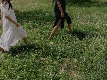 2 people walking in a field