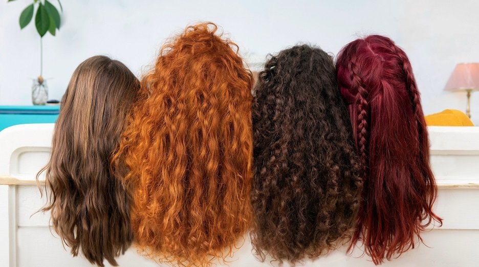 Shot of diverse group of models with burgundy, copper red, black, and blonde hair.