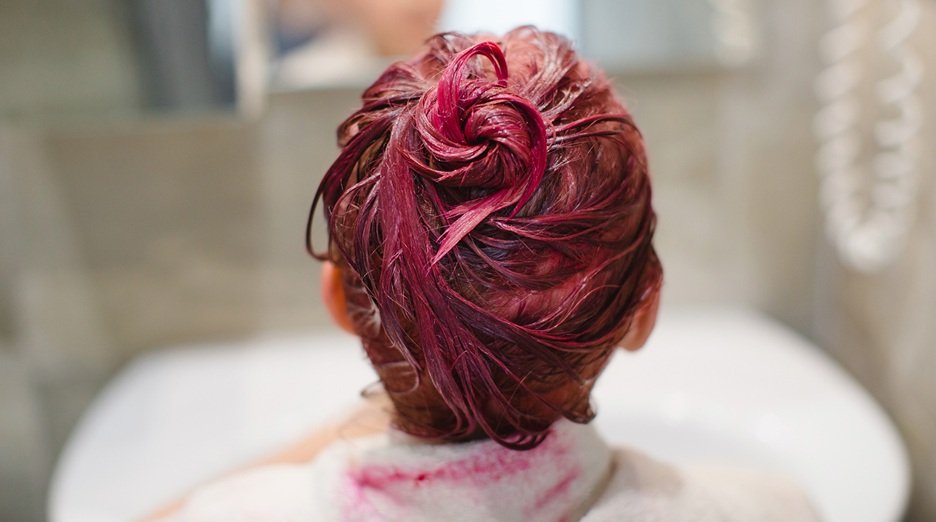 Women washing her hair with shampoo.
