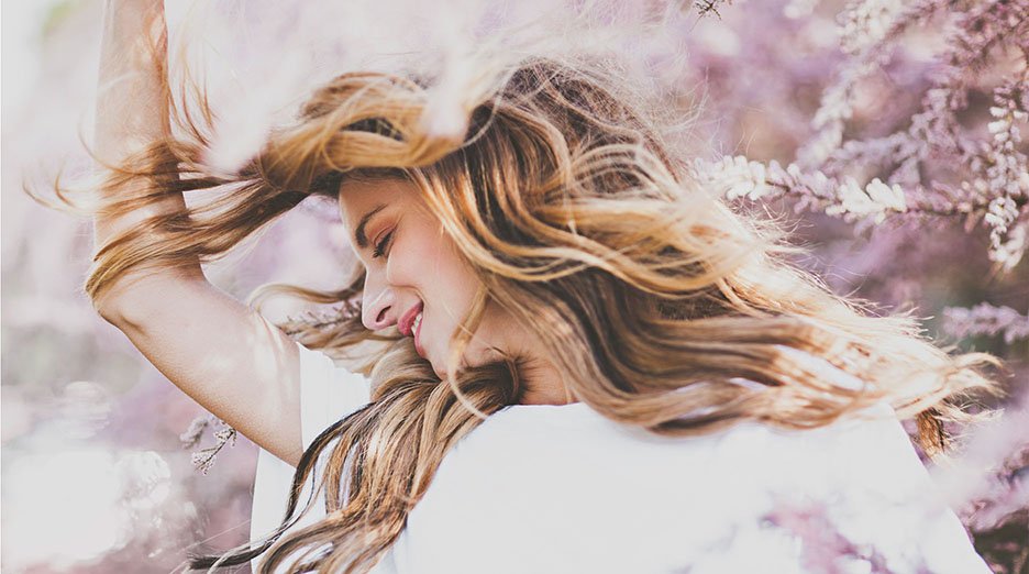 Close up portrait of a young woman with highlighted hair Enjoying The Springtime.