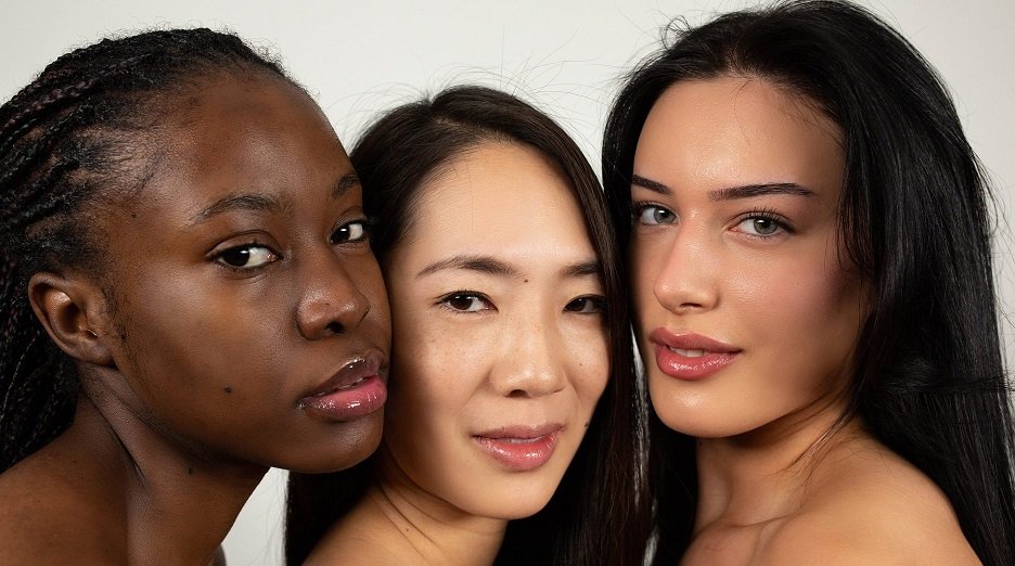 Three individuals with varying skin tones showcase the diversity of black hair shades.