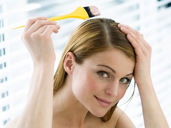 Women dyeing her light brown hair.