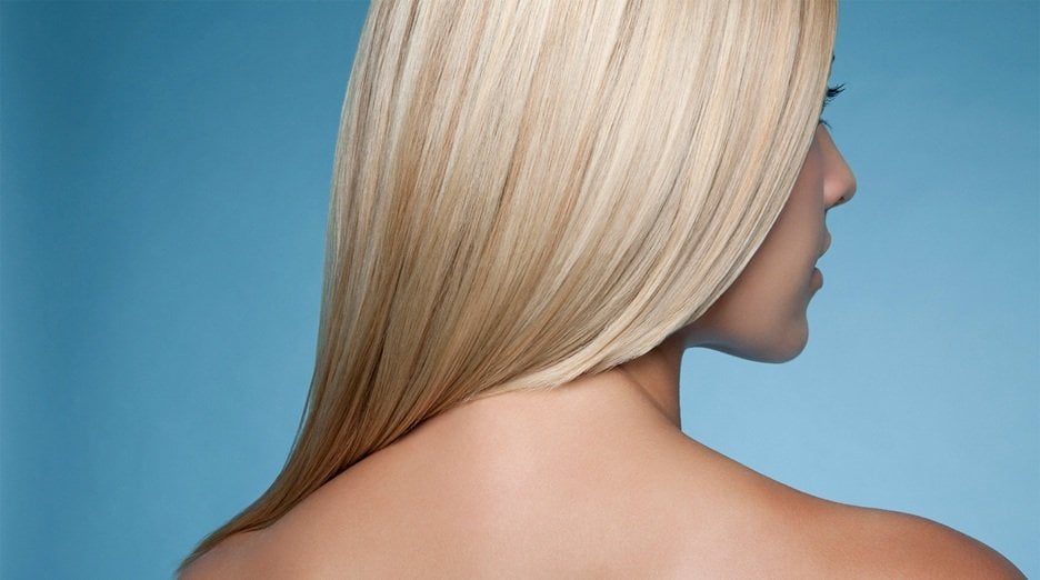 Back shot of a beautiful woman with bleached blonde hair.