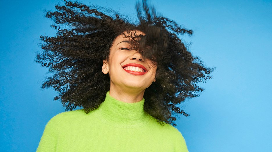 Young woman with black 3C curly hair.