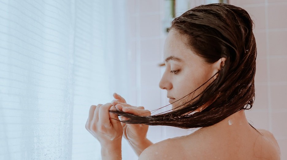 Woman Taking A Shower And Washing Her Hair At Home