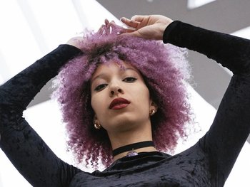Women with purple hair posing.