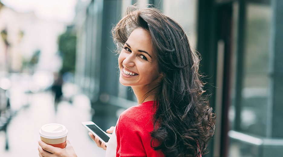 Woman with long hair looking back over her shoulder.