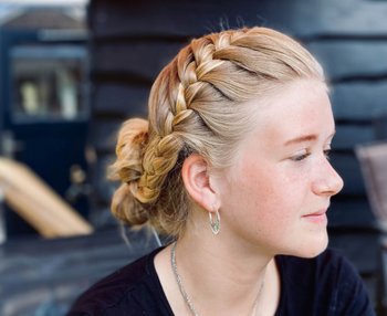 Blonde girl with side headband braid.