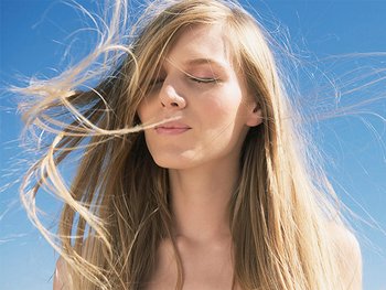 Woman with long hair blowing in the wind.