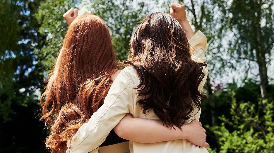 Two women with healthy-looking, long hair.