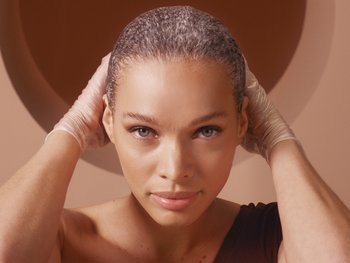 Close-up of a person applying a hair mask or oil treatment.
