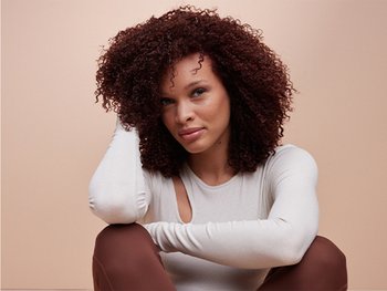 Woman with styled, voluminous curly hair.