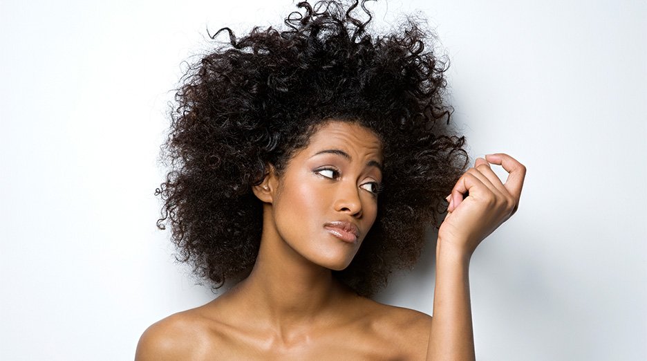Woman wondering how to fix frizzy hair - Garnier