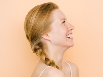 A woman with a simple side braid, showcasing an easy, casual hairstyle for medium-length hair.