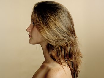 A woman with a straight, medium-length layered haircut.