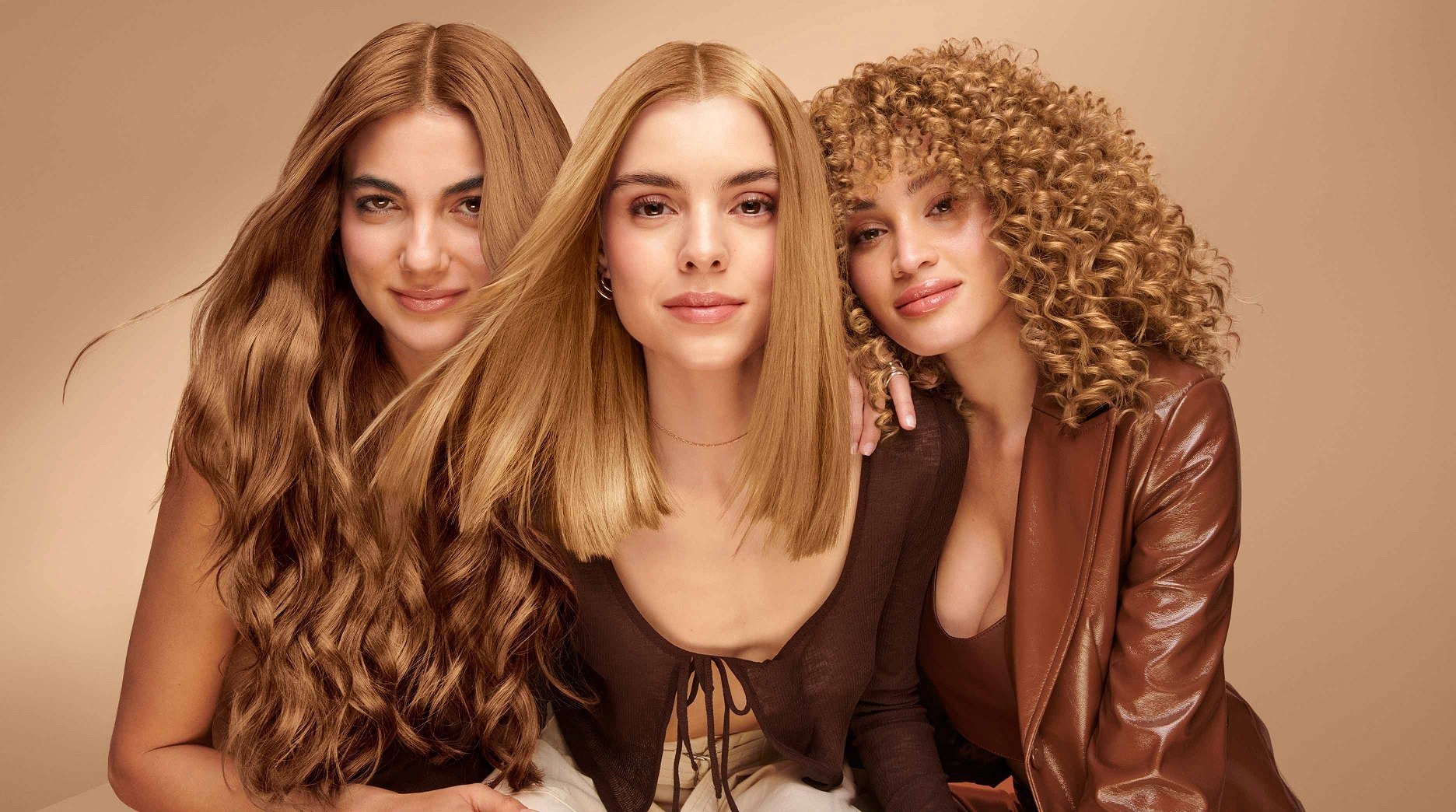 Models demonstrating the versatility of medium-length haircuts, suitable for various hair textures.