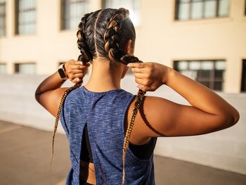 Young woman in sports wear standing outdoors