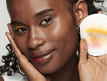 Person with a radiant complexion demonstrating the results of the best glass skin routine using chemical exfoliation.