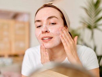 woman exfoliating skin