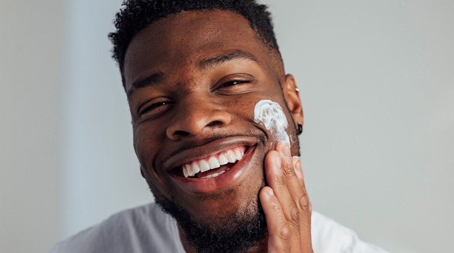 Garnier find the daily face moisturizer best your for skin. Man applying facial moisturizer to his face.