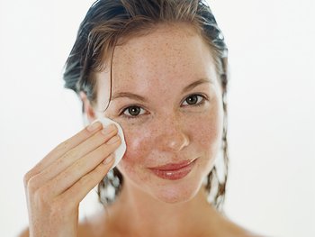 Women wiping her face with a skincare toner