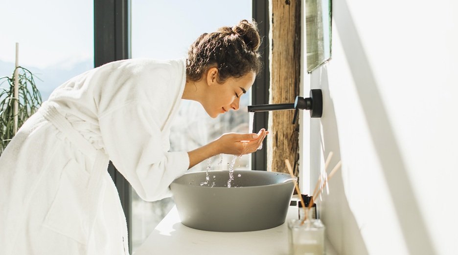 Women washing her face with a cleanser