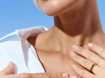 Focused shot of female model’s neck and collar bone.