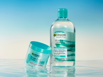 Micellar Cleansing Water with Hyaluronic Acid and Aloe with Erase It All Makeup Cleansing Balm with Hyaluronic Acid standing in water