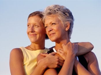 Two older women smiling together.