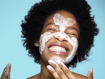 Woman applying a face scrub or mask.