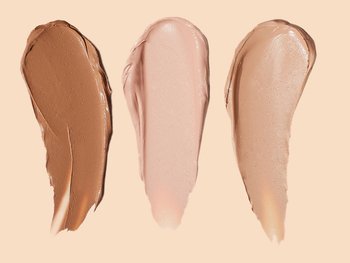 Three swatches of BB cream in different shades, ranging from light to dark, are displayed against a light peach background.