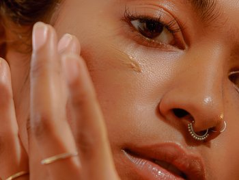 A close-up of a person applying BB cream.