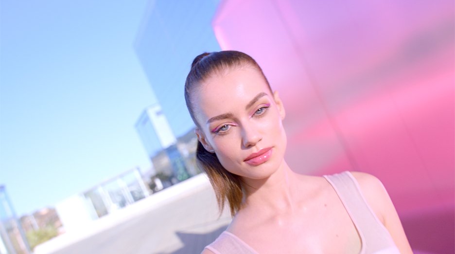 Front shot of beautiful model looking at camera. She has glowing, radiant skin.