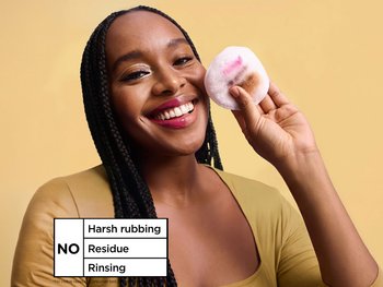 Woman showing half-removed makeup on her face and a cotton pad, demonstrating that Garnier Micellar Water requires no harsh rubbing, leaves no residue, and needs no rinsing