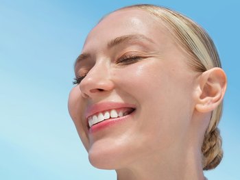 Woman smiling and looking upward.