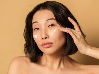 A close-up image of a woman demonstrating the skincare benefits of BB cream, emphasizing its hydrating and skin-tone evening qualities.