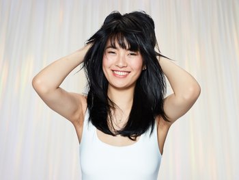 A smiling woman with mid-length, black hair.