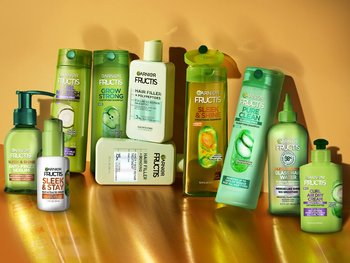 Assortment of Garnier Fructis hair care products, including shampoos, conditioners, and styling products, designed for various hair types and needs.