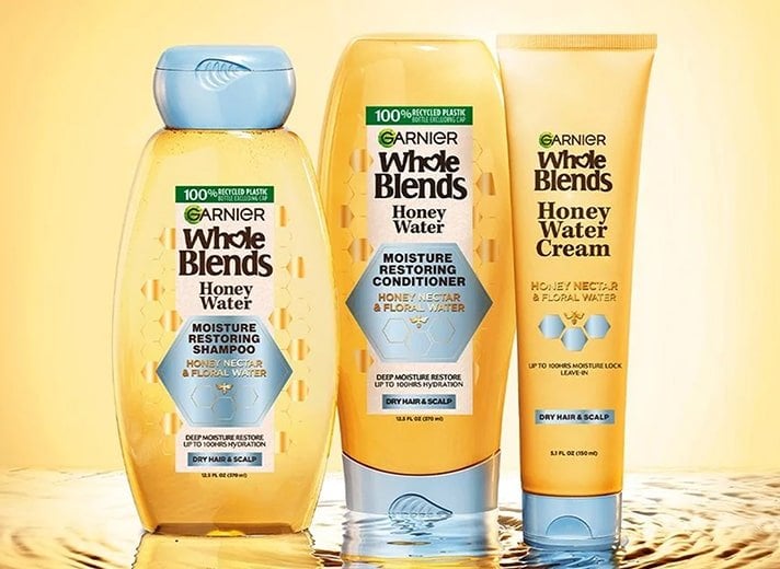 Quench and hydrate dry, thirsty hair with the Garnier Whole Blends Honey Water shampoo, conditioner, and leave-in treatment infused with honey.