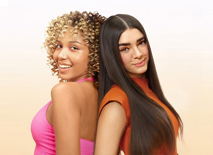 One woman has short, defined curls, while the other has long, sleek, straight hair, both demonstrating smooth, frizz-free results.