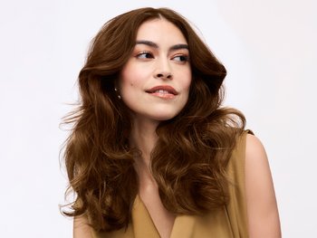 Brunette model posing wearing Olia hair color.