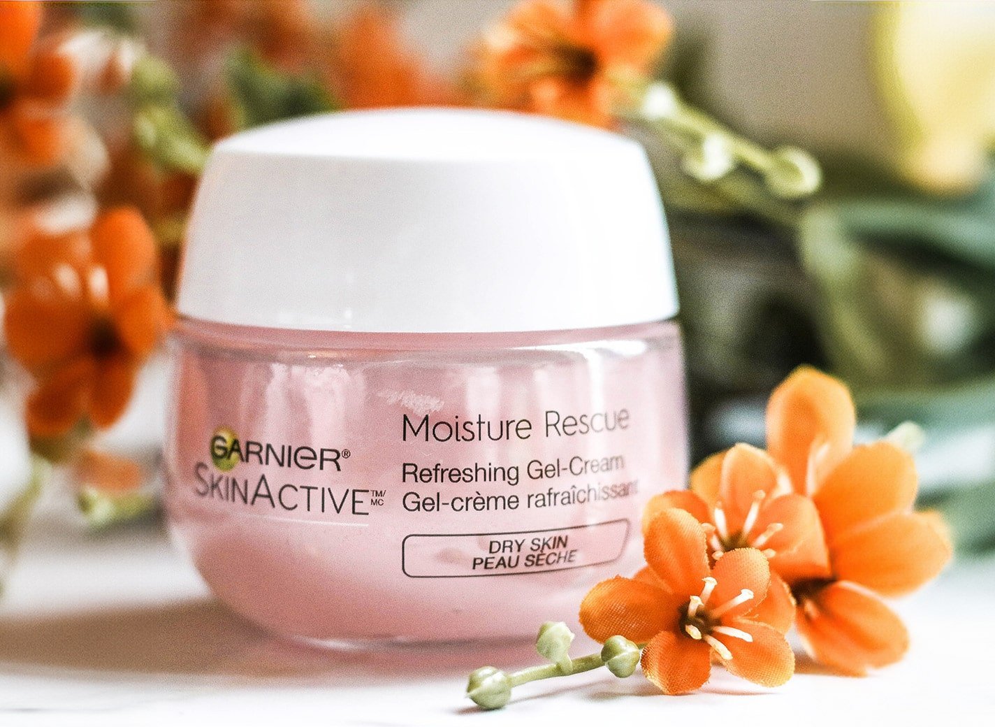 Garnier moisturizing cream against flower background