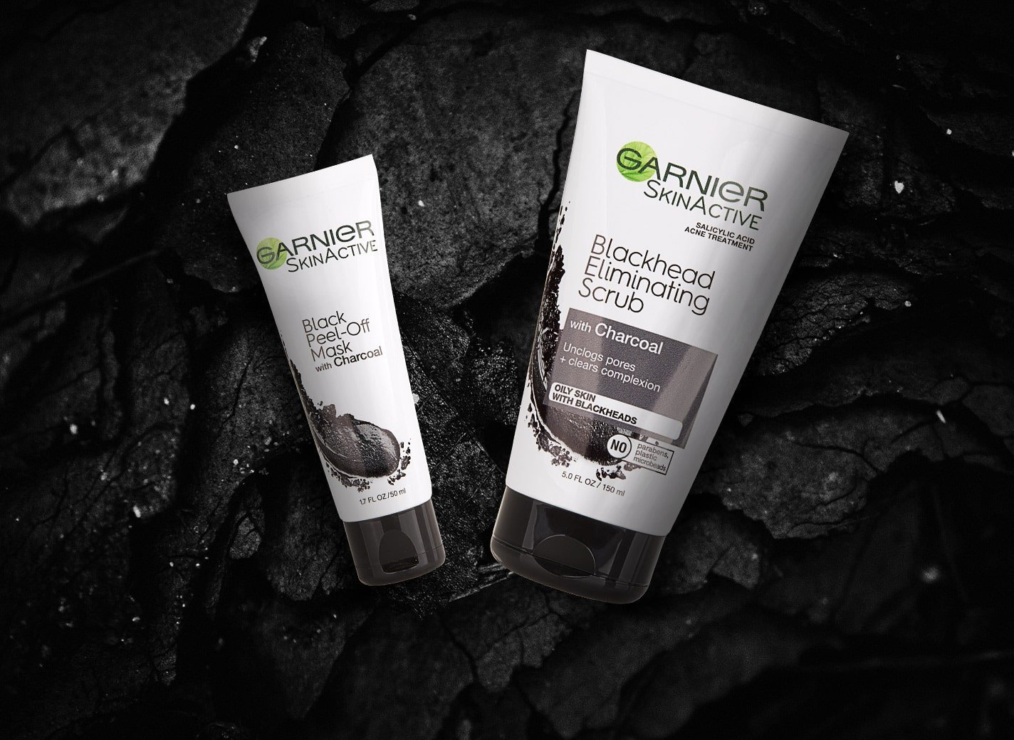 A Garnier scrub and mask against a charcoal background