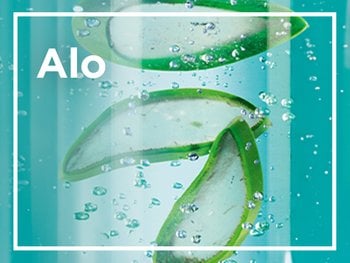 Green aloe vera leaf slices floating in clear, bubbly liquid, with the word "Alo" visible in white.