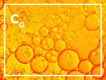 A close-up abstract image of orange and yellow oil droplets and bubbles, with the letter "C" and "G" visible in white.