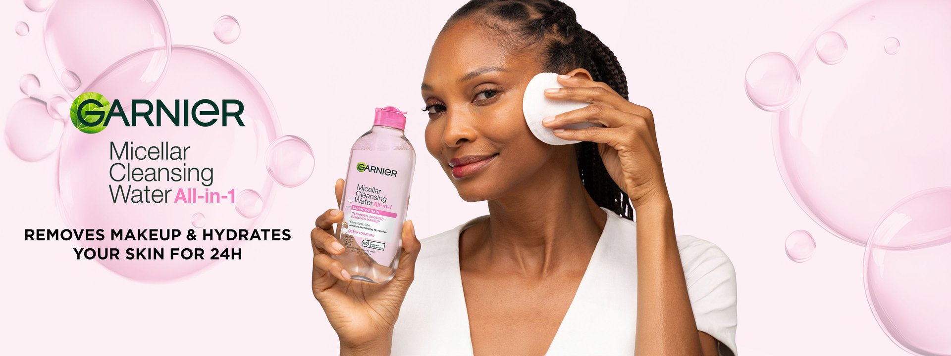 Garnier Micellar Cleansing Water All-in-1 for sensitive skin: woman demonstrating how to remove makeup and hydrate skin for 24H using a cotton pad with the Garnier micellar water bottle.