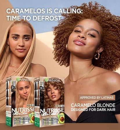 Garnier Ultra Color banner with a woman with long, straight blonde hair beside a woman with curly reddish-brown hair, promoting hair color products under the headline "Caramelos Is Calling: Time to Defrost" and two packs from the Caramelo Blonde hair color collection.